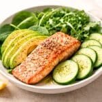 Low-carb salmon avocado bowl with leafy greens and cucumber for blood pressure support