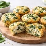 Egg muffins with spinach and feta cut open on a wooden board, low-carb breakfast recipe